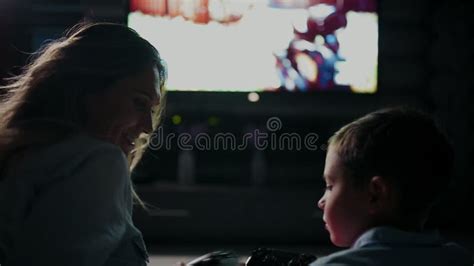 Mom With Son In Front Of Tv Playing Video Stock Footage.